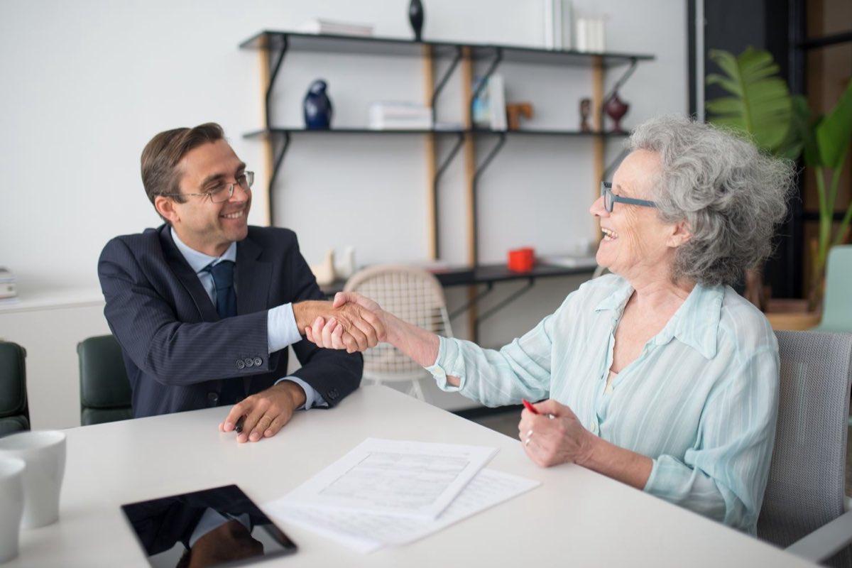 A consultant meeting a client across a desk
