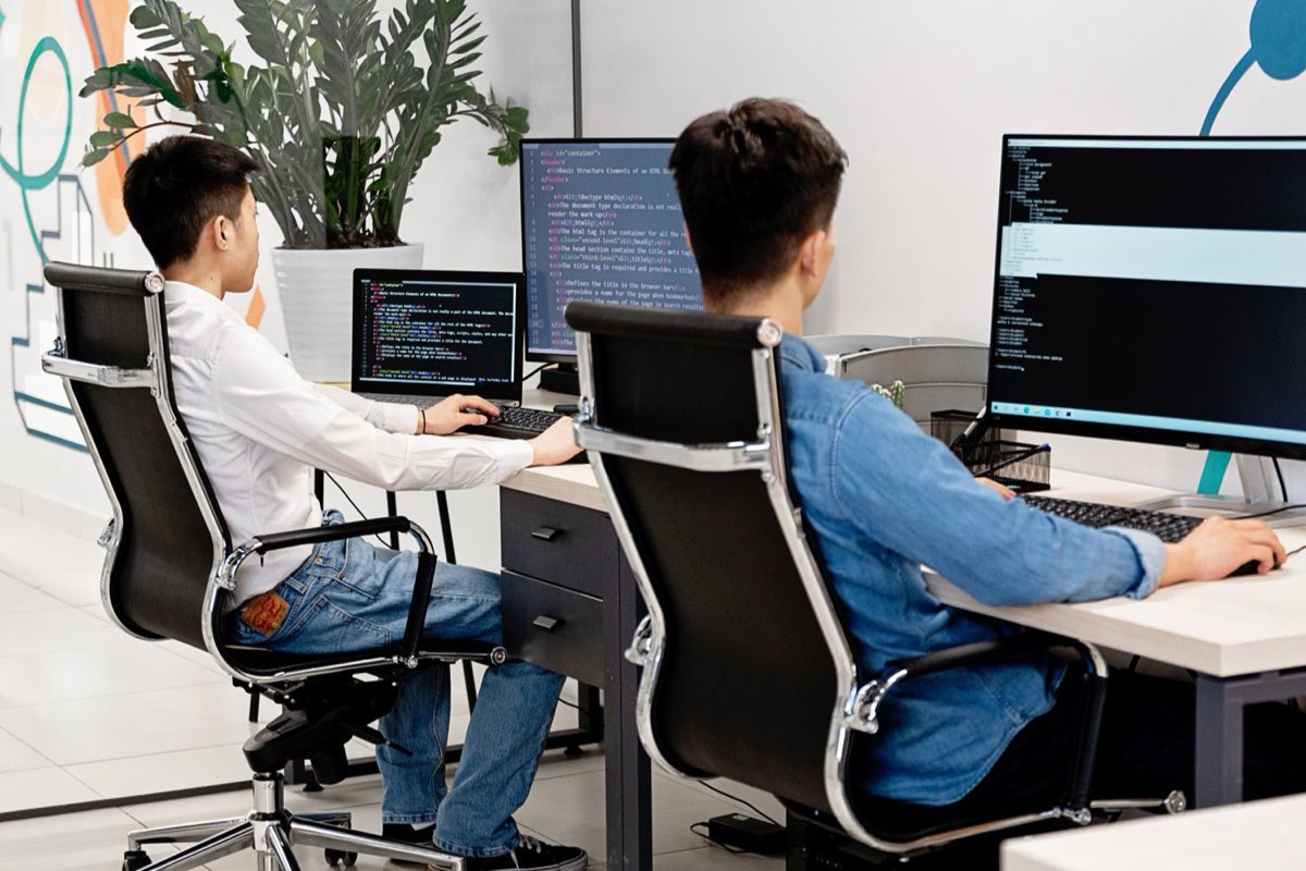 Developers working at monitors in a bright office