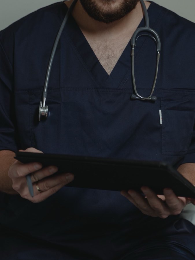 A clinician holding a tablet